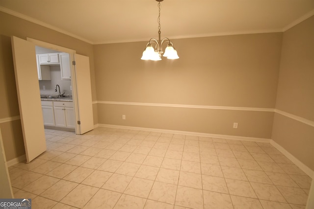 empty room featuring a chandelier, crown molding, sink, and light tile patterned floors