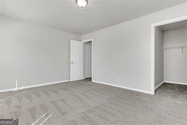 unfurnished bedroom featuring a closet, carpet, and a textured ceiling