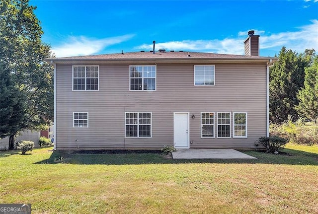 rear view of property featuring a patio and a yard