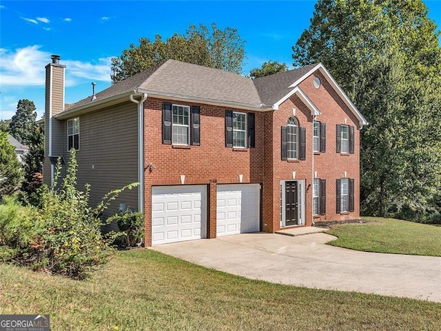 view of front of home featuring a garage and a front lawn