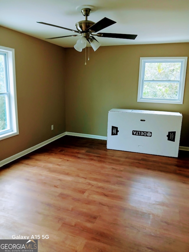 spare room featuring wood-type flooring and ceiling fan