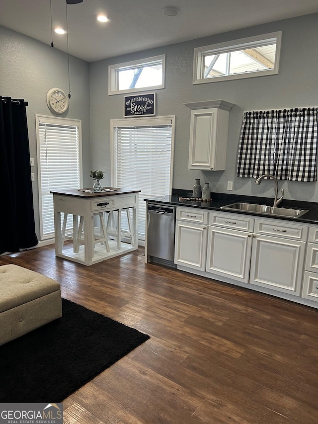 kitchen with dishwasher, plenty of natural light, sink, and white cabinetry