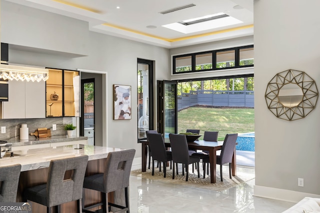 dining room featuring a skylight