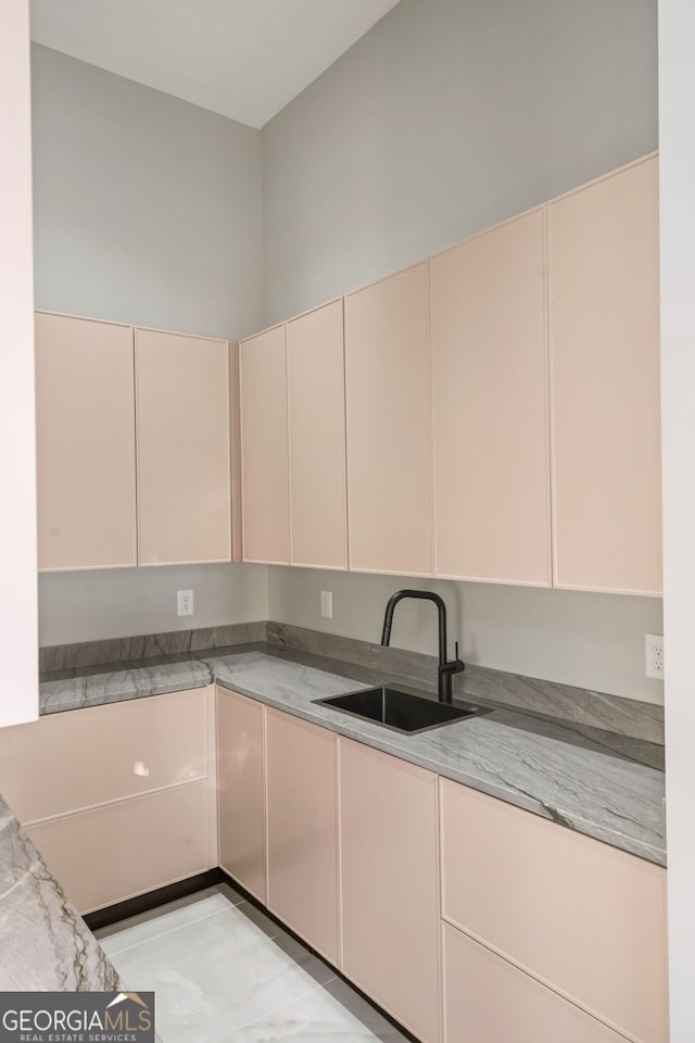 kitchen with sink and light stone countertops