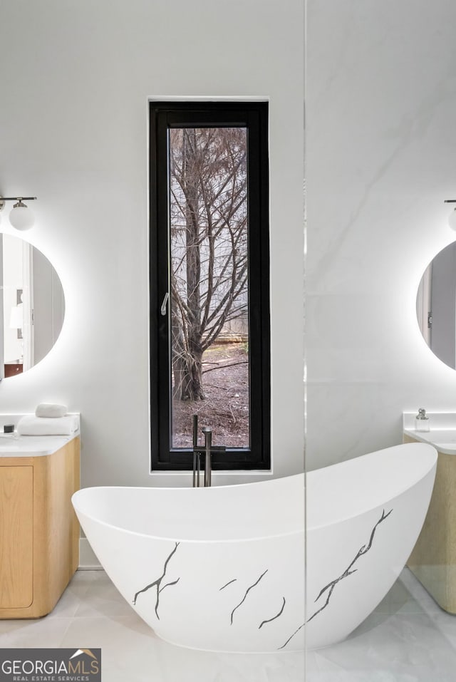 bathroom with vanity and a tub to relax in