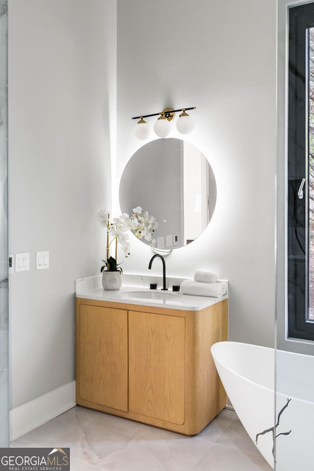 bathroom with vanity and a tub