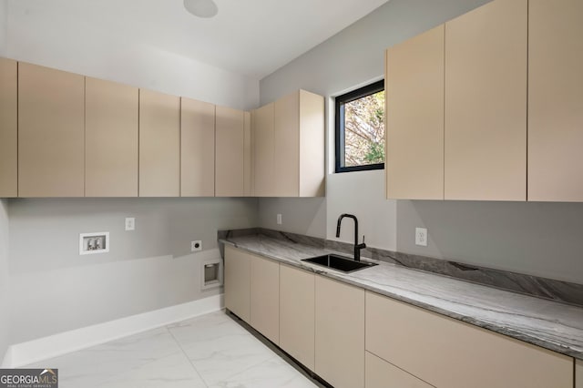 kitchen featuring sink, light stone counters, and cream cabinetry