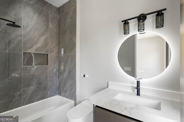 full bathroom with tiled shower / bath, vanity, and toilet