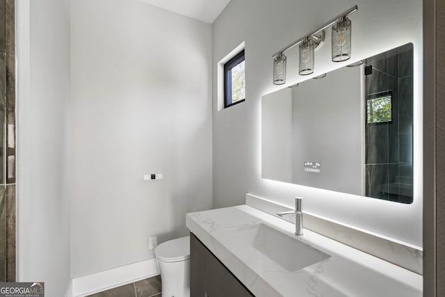 bathroom featuring vanity, toilet, and tile patterned flooring