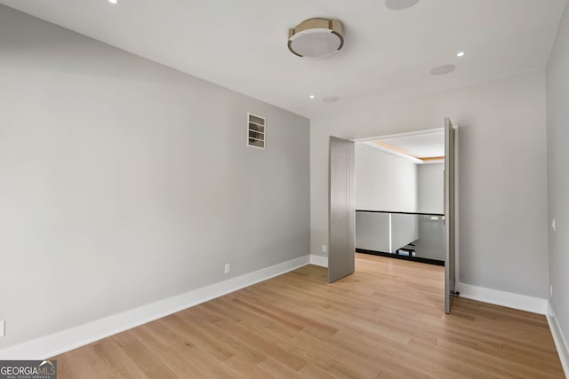 unfurnished room featuring light hardwood / wood-style flooring