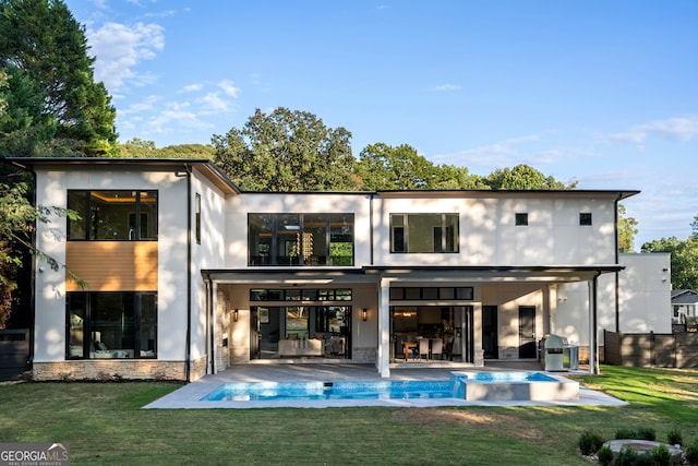 back of house with a yard and a patio area