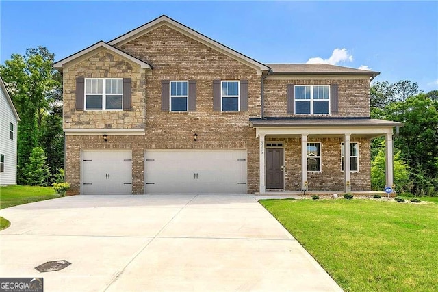 view of front of home with a garage and a front lawn