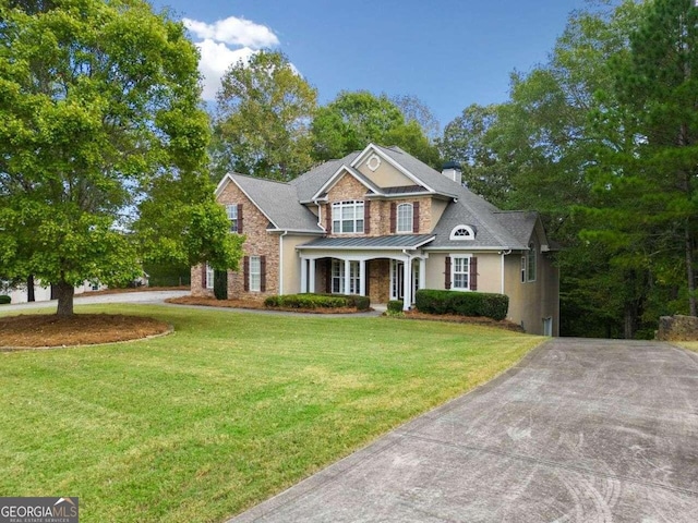 view of front of property with driveway, a front yard, and stucco siding