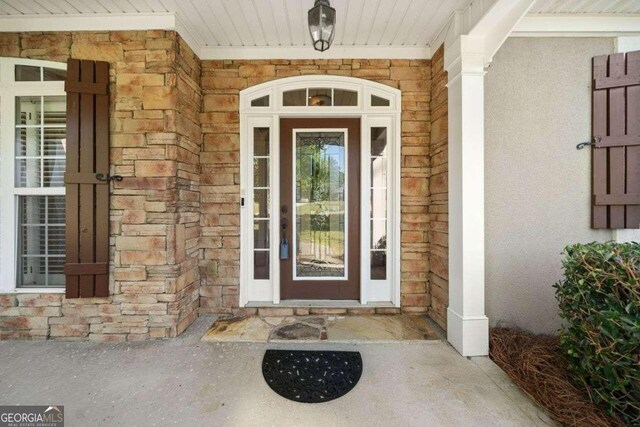 view of exterior entry featuring a porch