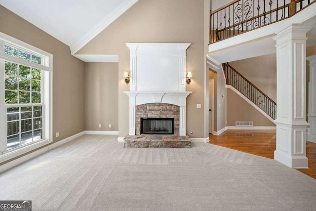unfurnished living room with stairway, a stone fireplace, visible vents, carpet floors, and baseboards