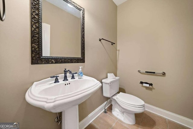 bathroom with tile patterned flooring and toilet