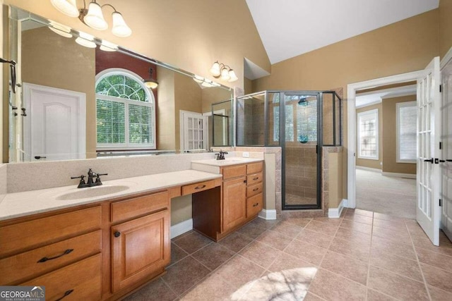 bathroom with vanity, lofted ceiling, tile patterned flooring, and a shower with door