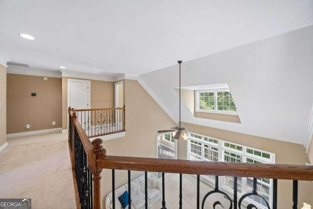 hall featuring recessed lighting, a high ceiling, light carpet, an upstairs landing, and baseboards