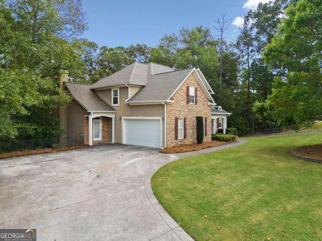 traditional home featuring concrete driveway, a front lawn, stone siding, fence, and stucco siding