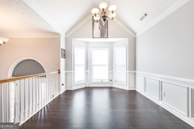 interior space featuring a textured ceiling, lofted ceiling, crown molding, and dark wood-type flooring