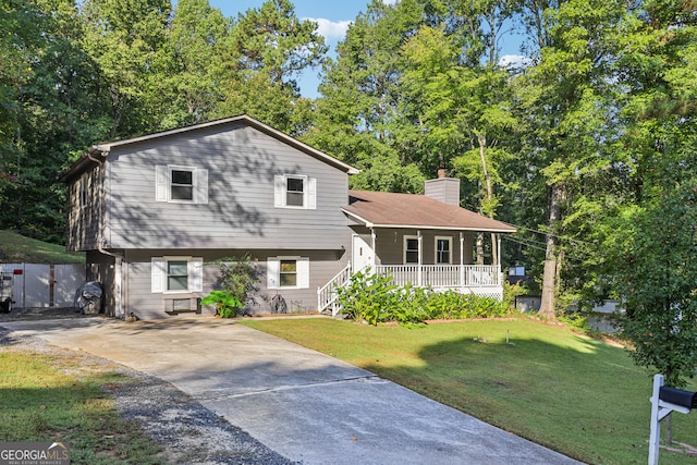 tri-level home featuring a front yard and a porch