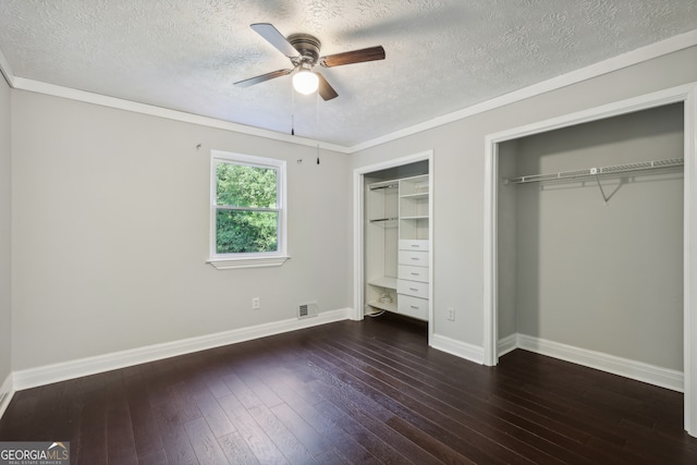 unfurnished bedroom with crown molding, dark hardwood / wood-style floors, a textured ceiling, and ceiling fan