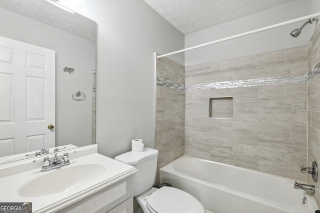 full bathroom featuring vanity, toilet, tiled shower / bath combo, and a textured ceiling