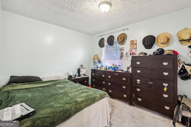 carpeted bedroom with a textured ceiling