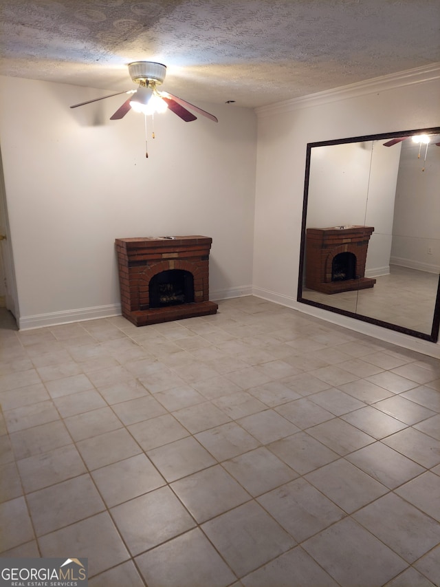 unfurnished living room with ceiling fan, a textured ceiling, and a brick fireplace