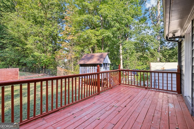 wooden deck with a yard and a shed