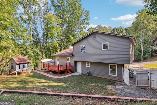 back of property with a wooden deck, a storage unit, and a lawn