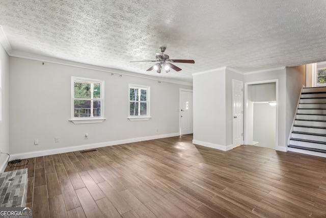 unfurnished living room with a textured ceiling, wood-type flooring, and plenty of natural light