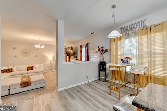 dining space with a chandelier and hardwood / wood-style floors