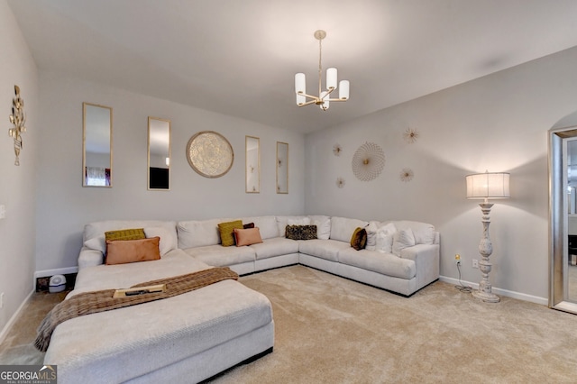 carpeted living room with a chandelier