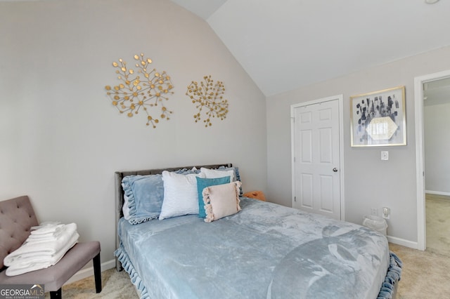 bedroom with lofted ceiling and light carpet