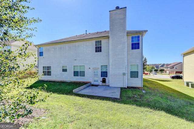 back of property featuring a lawn and a patio