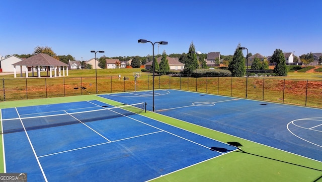 view of basketball court featuring a gazebo, tennis court, and a yard