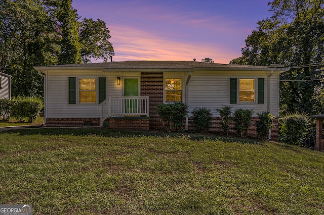 ranch-style house with a lawn