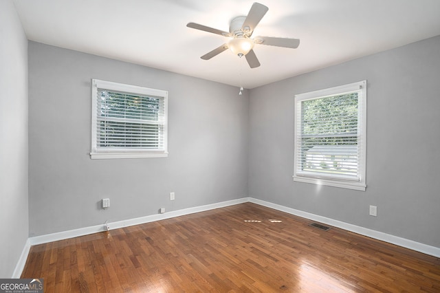 empty room with hardwood / wood-style flooring and ceiling fan