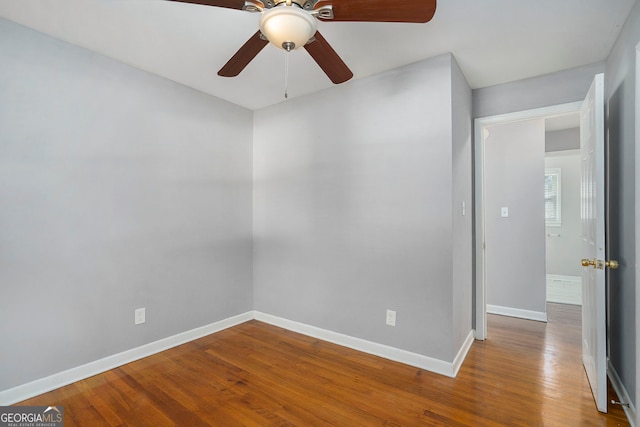 empty room with hardwood / wood-style floors and ceiling fan