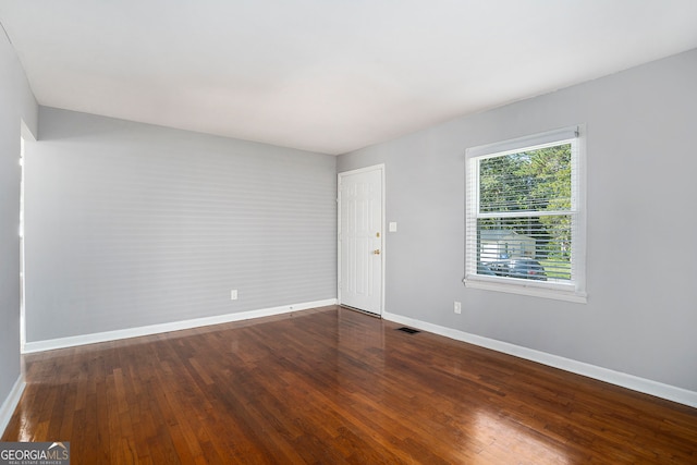 spare room with wood-type flooring