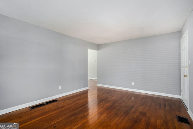 empty room featuring dark wood-type flooring