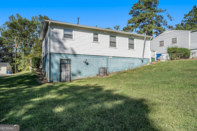 rear view of property with a yard