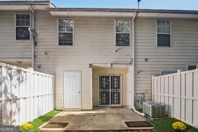 rear view of house featuring central air condition unit and a patio