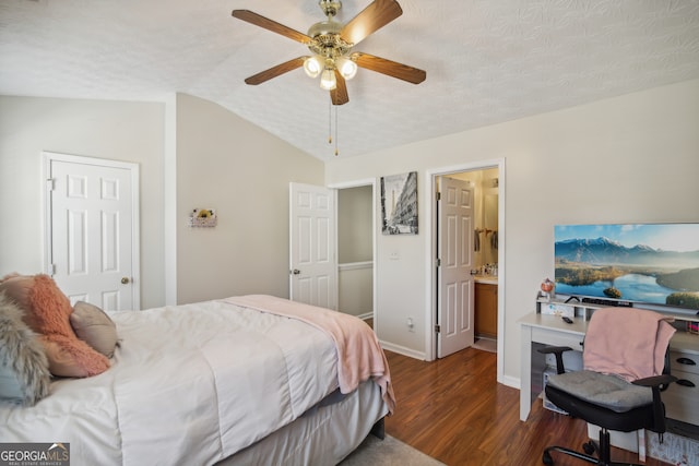 bedroom with lofted ceiling, ceiling fan, dark hardwood / wood-style floors, and a textured ceiling