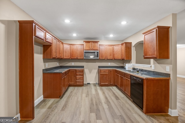 kitchen featuring sink, light wood-type flooring, and black dishwasher