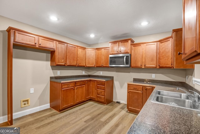 kitchen with sink and light wood-type flooring