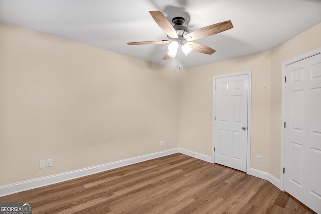 unfurnished bedroom featuring hardwood / wood-style floors and ceiling fan