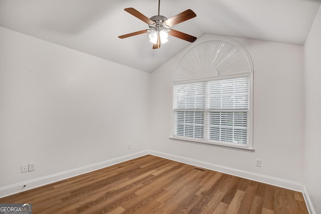 unfurnished room with lofted ceiling, ceiling fan, and wood-type flooring