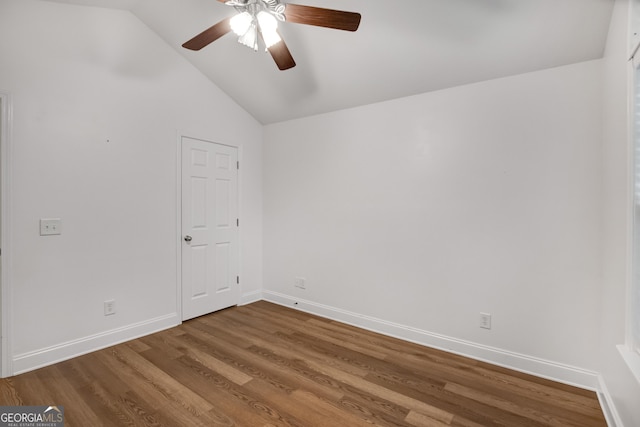 spare room featuring hardwood / wood-style flooring, ceiling fan, and lofted ceiling